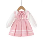Custom pink and white baby sailor dress, featuring a large striped sailor collar, long sleeves, and an elegant pleated skirt. Premium infant girl's preppy occasion dress from a professional OEM/ODM clothing manufacturer.
