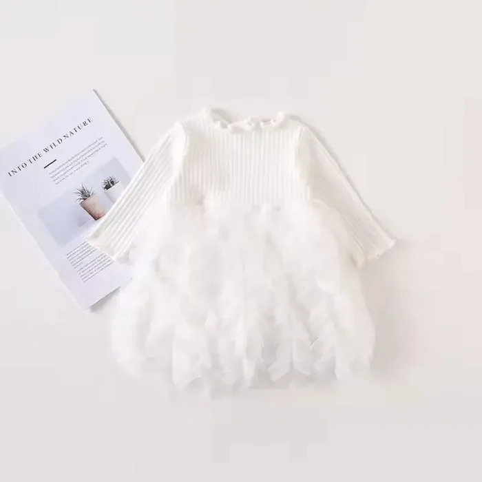 Custom white baby gala dress, featuring a unique faux-feather textured skirt, long sleeves, and ethereal voluminous silhouette. Premium infant girl's christening and occasion wear from a professional OEM/ODM clothing manufacturer.