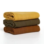 A stack of solid-colored baby washcloths in mustard yellow, olive green, and brown, from a China baby washcloths manufacturer.