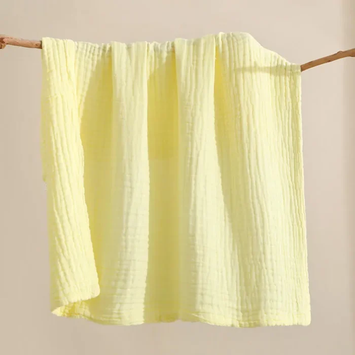 Light yellow cotton muslin baby washcloth with crinkle texture, manufactured by a China baby washcloths factory.