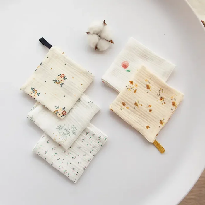 A set of patterned baby washcloths with fruit and floral prints, made of soft natural cotton by a China manufacturer.
