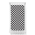 Black and white checkered crib sheets on a baby bed from a crib sheets manufacturer in China.