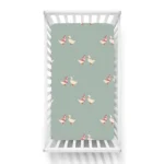 Cute duckling pattern crib sheets in sage green on a baby bed, produced by a crib sheets manufacturer in China.