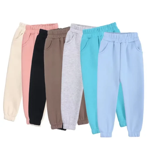 Display of custom baby joggers in multiple colors, including heather grey, black, pink, cream, and vibrant blue. Premium cotton fleece infant sweatpants collection from a professional OEM/ODM clothing manufacturer in China.